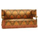 An early 20th century Knole drop end sofa, with flamboyantly coloured printed upholstery, on brass