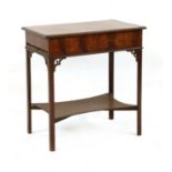 A George III mahogany dressing table, the moulded rectangular top openng to reveal a fitted