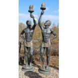 A pair of bronze garden statues modeled as a pair of Blackamore figures with outstretched arm