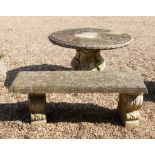 A circular reconstituted stone garden table
