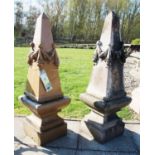 A pair of glazed obelisks, each with moulded swags, on plinths, 94 cm high (4)