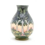 A modern Moorcroft vase, decorated with trees in a landscape, stamped and painted marks to the base,