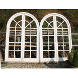 Two pairs of large white painted arch top doors, in frames, 155cm x 243cm overall