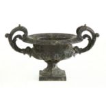 A cast iron and black painted urn
