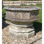 A reconstituted stone octagonal font