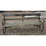 A wrought iron and slatted garden bench, 183 cm wide