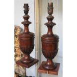 A pair of carved mahogany urn form table lamps