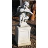 A white painted stone putti playing the violin on square plinth base