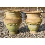 A pair of terracotta twin handled olive jars