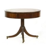A circular mahogany drum table
