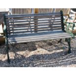 A pair of green painted metal and teak garden benches