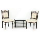 A pair of ebonised single chairs