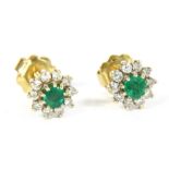 A pair of gold emerald and diamond cluster earrings