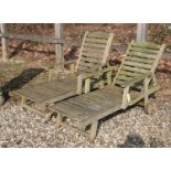 A pair of teak garden loungers with adjustable slatted backs