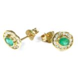 A pair of 9ct gold emerald and diamond oval cluster earrings, 1.2 g
