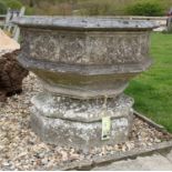 A reconstituted stone octagonal garden font