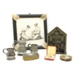 A cast iron money bank, two Royal Life Saving Society medals, a gilt box, pewter measures