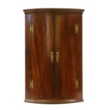 A mahogany corner cupboard