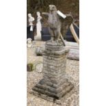 A reconstituted stone eagle on brickwork plinth