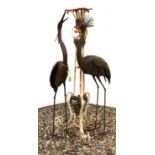 A pair of metal birds , 138cm high, and a wrought iron stand (3)