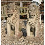 A pair of reconstituted stone seated lions on rectangular plinth base