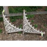 Two metal garden wall brackets with decorative floral pattern