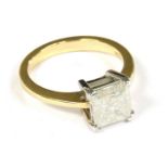 An 18ct gold single stone square-cut diamond ring, claw set with tapering shoulders and a p.p.