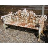 A cast iron white painted garden bench, the interlocked leaf decorated back above geometric pierced