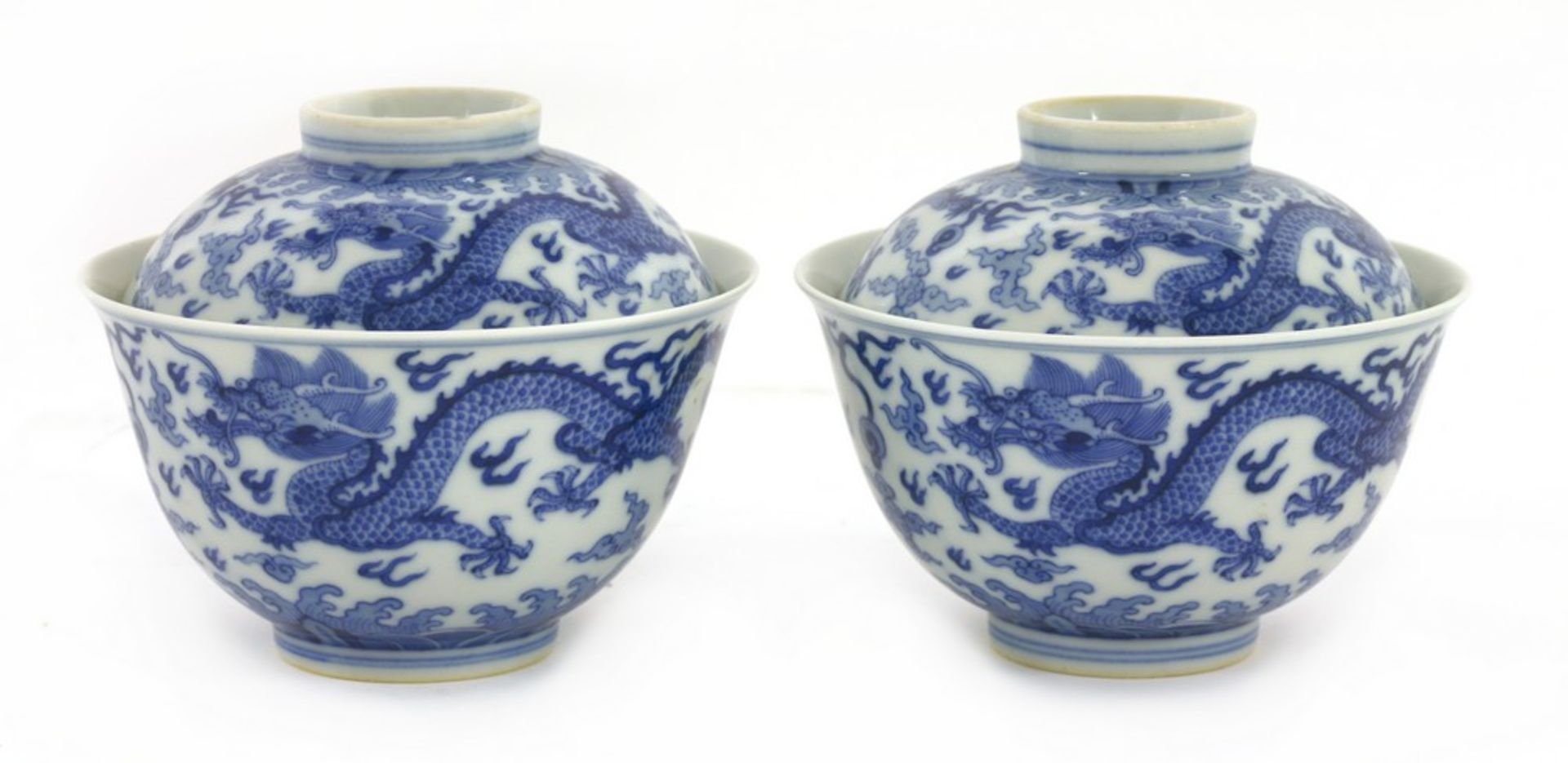 A pair of Chinese blue and white bowls and covers