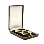 A fitted cased for a single row cultured pearl necklace,