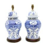 A pair of Chinese blue and white lidded urns