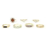 A collection of seven gold and stone set rings