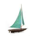 A vintage pond yacht, complete with sail