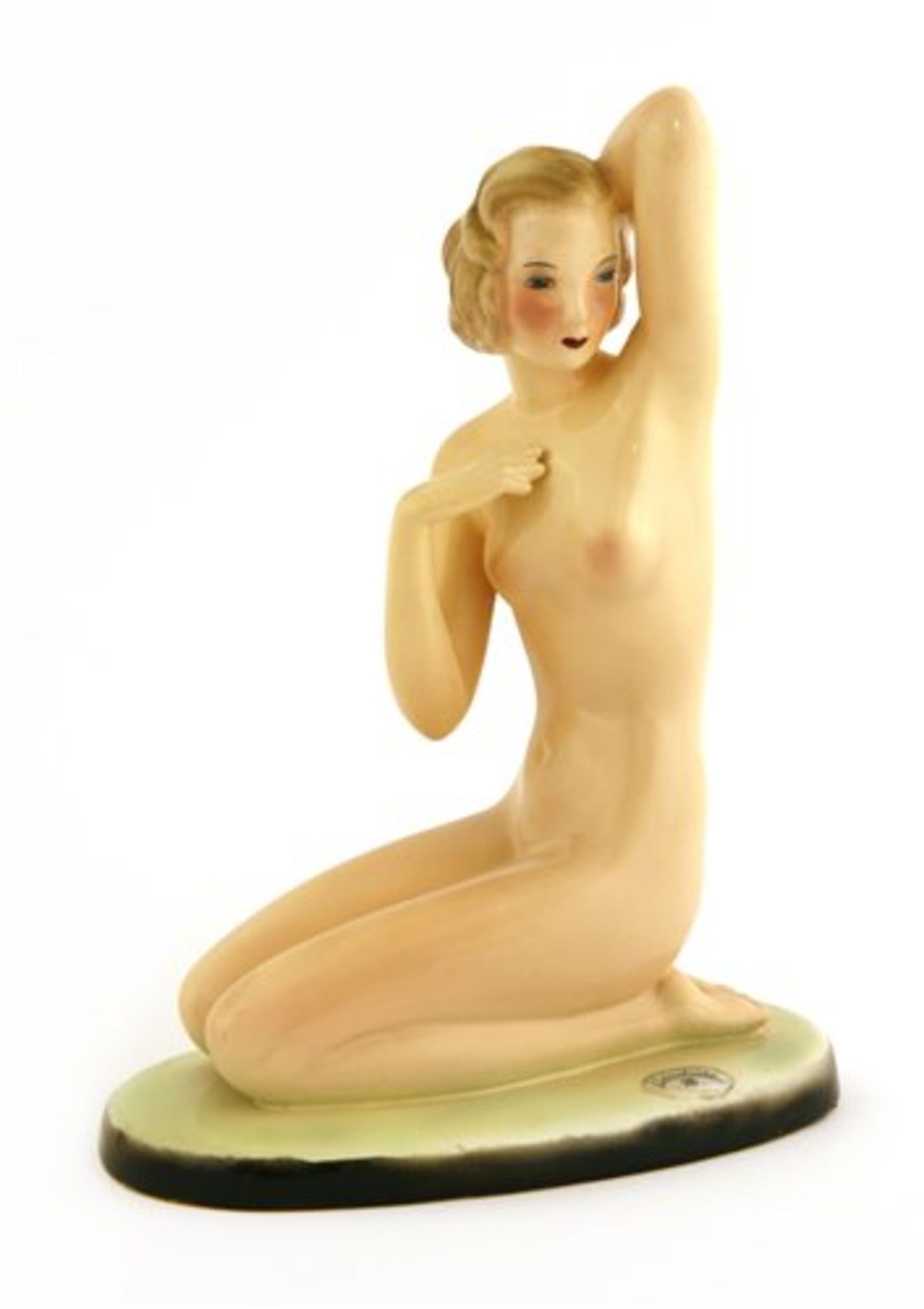 A Goldscheider figure of a kneeling nude,