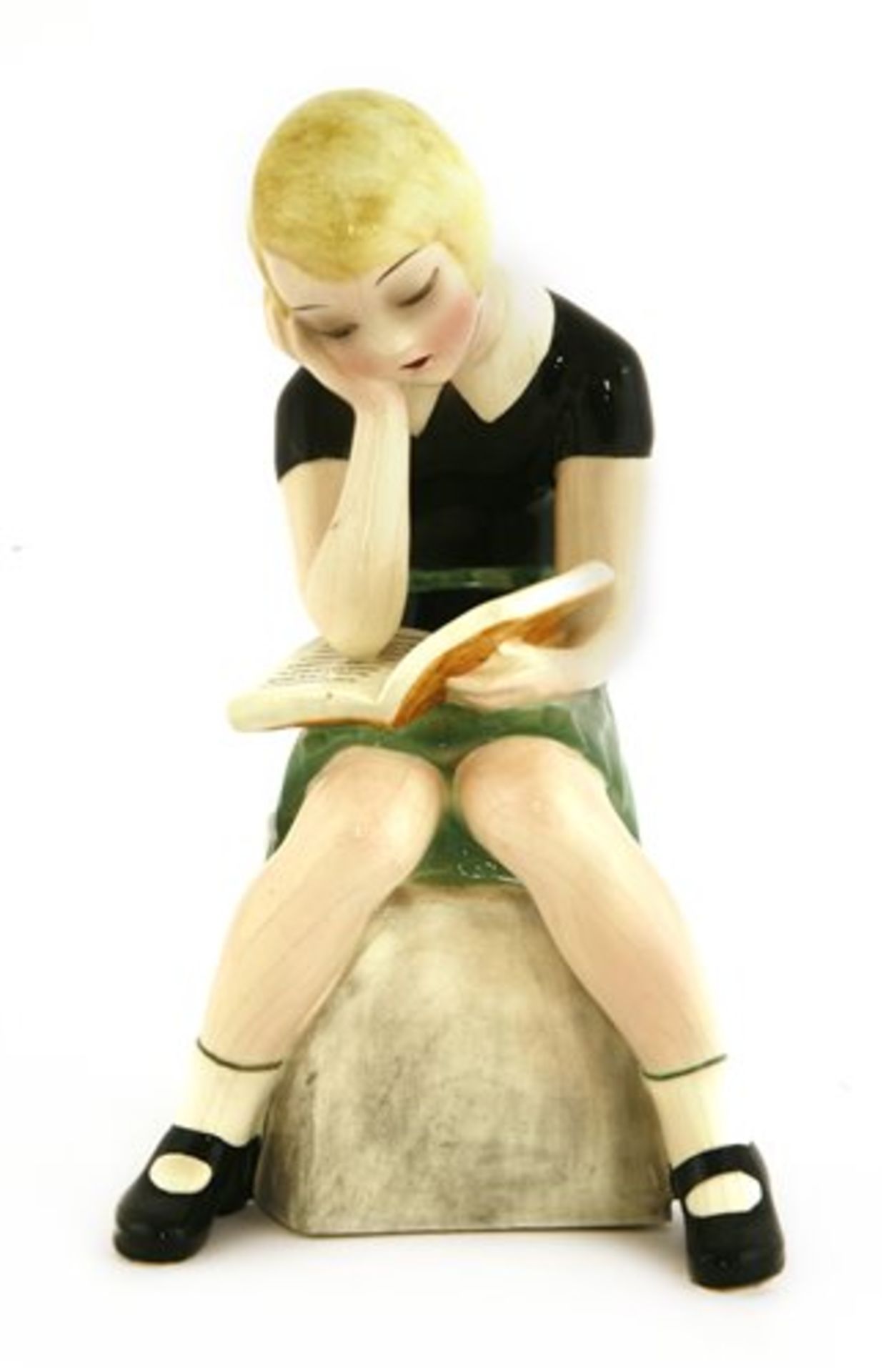 A Goldscheider figure of a girl reading a book,