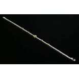 A yellow and white gold diamond set line bracelet,