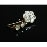A single stone diamond set daisy cluster drop earring
