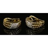 A pair of gold diamond set half hoop earrings,