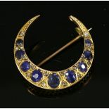 An Edwardian sapphire and diamond closed crescent brooch,