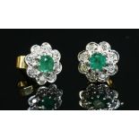 A pair of gold emerald and diamond daisy cluster earrings,