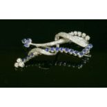 An 18ct white gold sapphire and diamond brooch