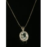 An Italian white gold aquamarine and diamond cluster pendant