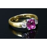 An 18ct yellow and white gold pink sapphire and diamond three stone ring,