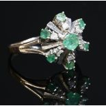 An 18ct white gold emerald and diamond cluster ring, c.1970,