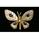 A gold mother of pearl, tanzanite and ruby butterfly pendant