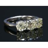 An 18ct white gold three stone diamond ring,