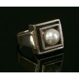 A white gold Art Deco style single stone cultured pearl ring