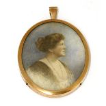 A painted miniature of an Edwardian lady set in an enamel picture frame pendant