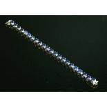 An 18ct white gold sapphire and diamond line bracelet,