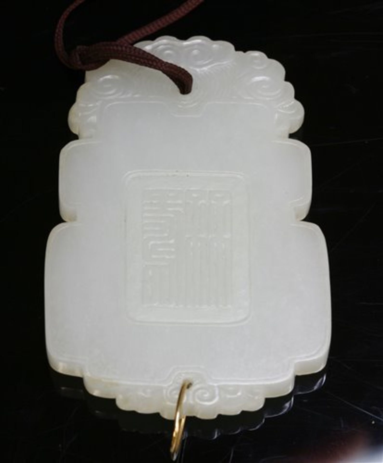 A Chinese carved celadon nephrite Pei,